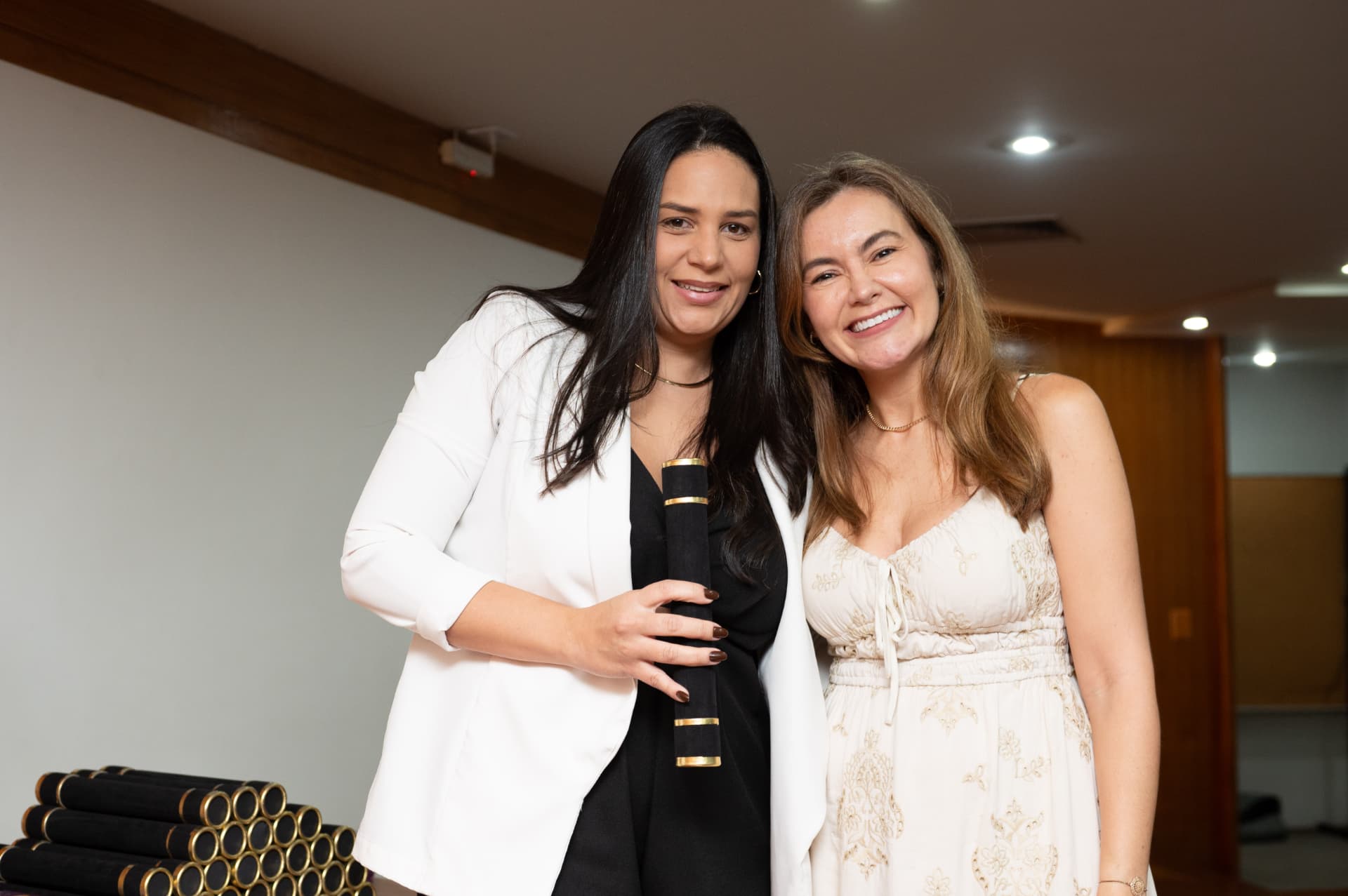 Turma 01 da Pós 2026 — formanda de blazer branco com o diploma